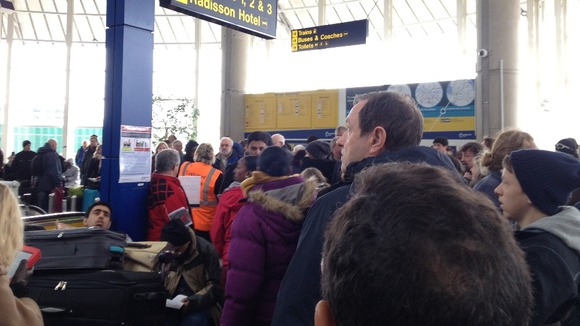 Crowds wait for news following the evacuation of Terminal One at Manchester Airport