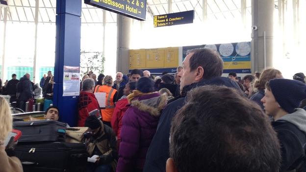 Crowds wait for news following the evacuation of Terminal One at Manchester Airport