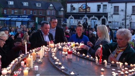 Villagers light candles