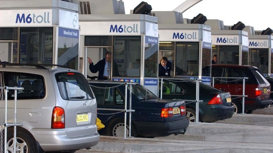Vehicles approaching Britain's first motorway toll on the M6 in Staffordshire