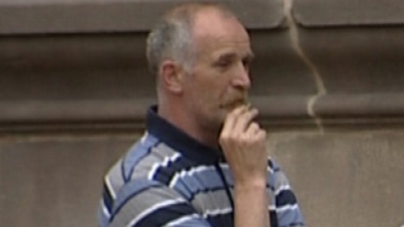 Paul Mosley pictured having a cigarette outside one of the early court hearings