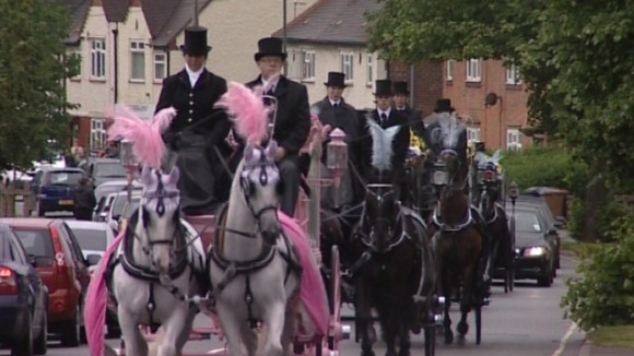 Horse drawn carriages carried each of the children’s coffins to church