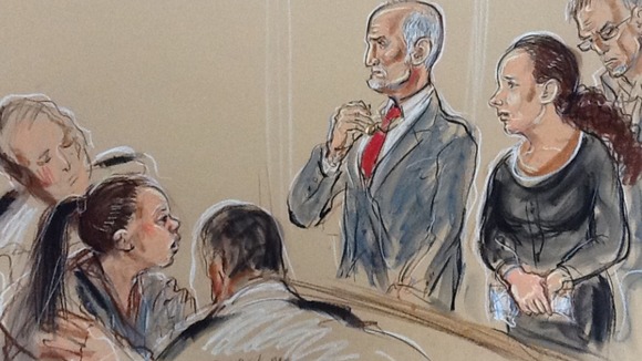 A court sketch shows a woman being held back after causing a disturbance from the public gallery.