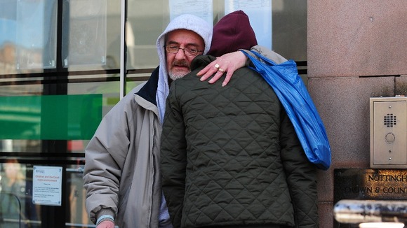 Jimmy Duffy, the father of Mairead Philpott, hugs a family friend outside Nottingham Crown Court.