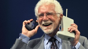 Martin Cooper holds the Motorola DynaTAC phone, the world's first commercial handheld cellular phone and a more recent model.