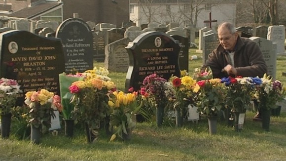Brian Smith leaves flowers on the grave of his son