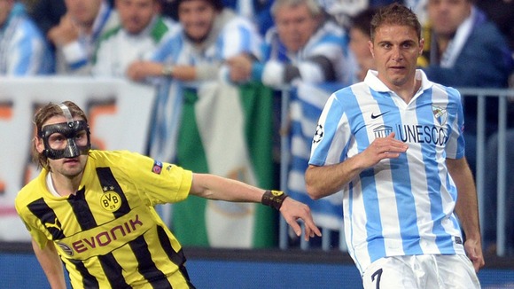 Dortmund's Marcel Schmelzer and Malaga's Joaquin vie for the ball