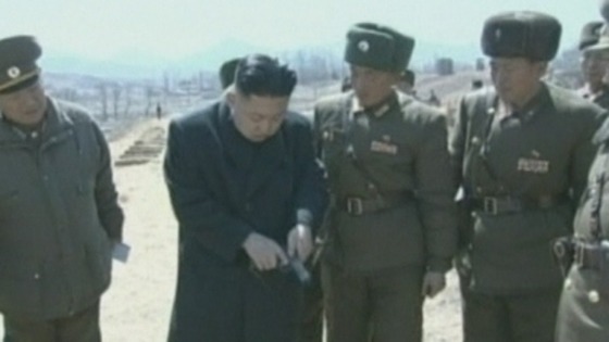Kim Jong-Un is given a handgun by one of the soldiers