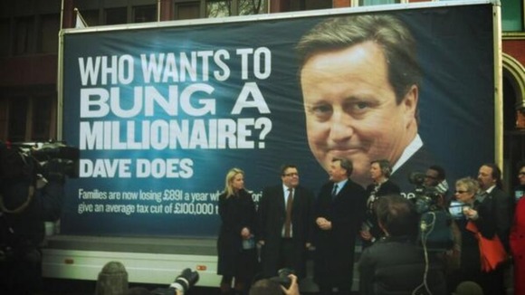 Labour unveil their new poster to mark the reduction in the 50p tax rate.