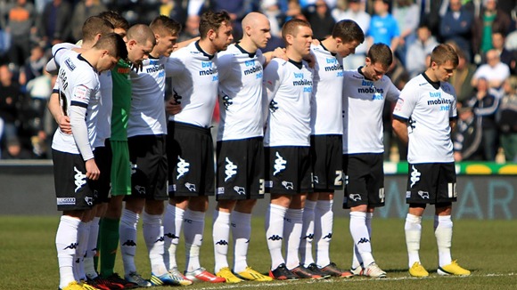 Derby County players observe a minute's silence in memory of the six children who lost their lives in a house fire on Victory Road.