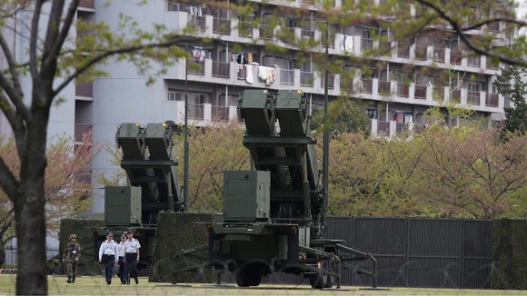Units of Patriot Advanced Capability-3 (PAC-3) missiles stand in front of a housing complex, at the Defence Ministry in Tokyo