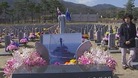 A mother visits her son's grave in a war cemetery in South Korea