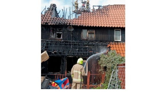 Firefighters tackle the fire.