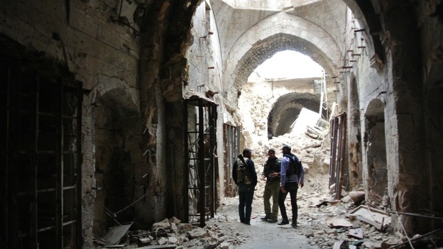 Free Syrian Army members patrolling inside the Great Mosque in Aleppo.