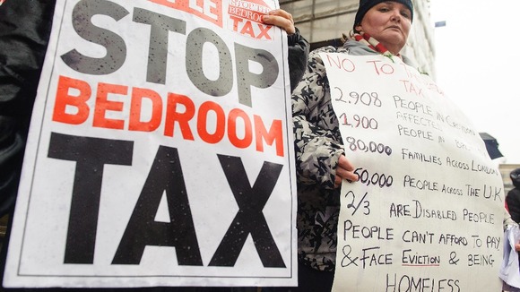 Protestors take part in a demonstration outside Croydon Town Hall in Surrey, against the government's proposed 'Bedroom Tax'.
