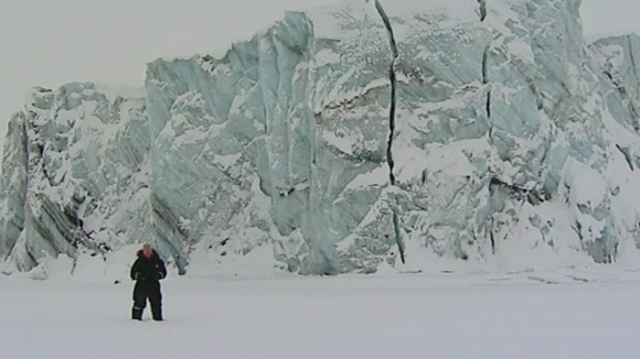 Science Editor Lawrence McGinty stands in front of a glacier in Svalbard, Norway