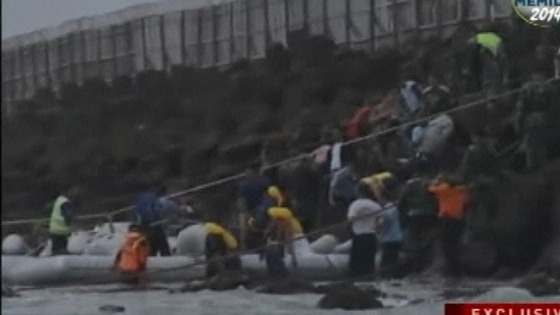 Rescue efforts on the shore.