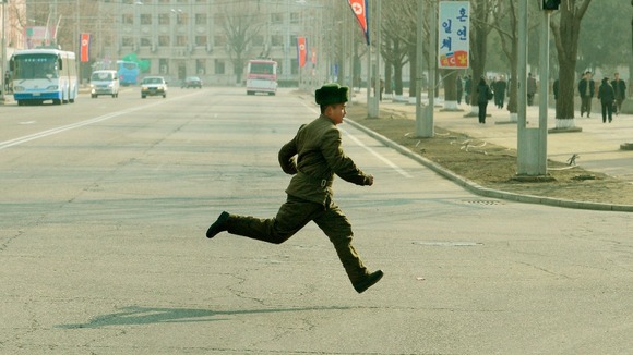 A North Korean soldier runs across a street in Pyongyang yesterday.