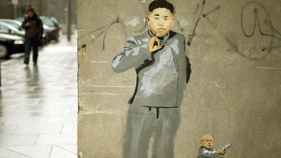 North Korean leader Kim Jong-un is given an 'Austin Powers' makeover by Dublin graffiti artist Solus.