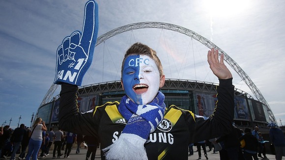 A young Chelsea fan arrives at Wembley Stadium ahead of the game