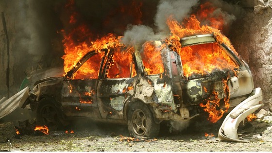 A car goes up in flames near the scene of a blast in Mogadishu 