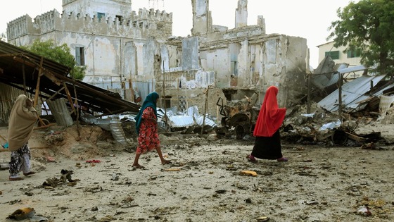 Somali women walk past the site of a deadly blast in Mogadishu 