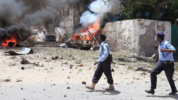 Somali policemen take up position near the scene of a deadly blast in Mogadishu.
