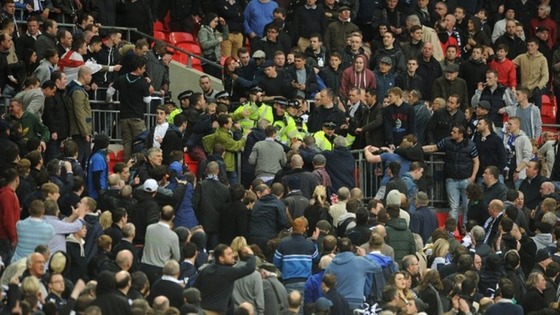 Trouble breaks out in the stands between the Millwall fans and police.
