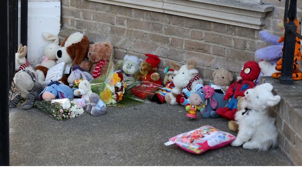 Tributes lay outside the house in Lowestoft where three children were found dead.