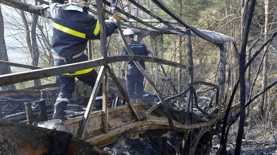 Emergency service workers inside the shell of the coach this afternoon. 