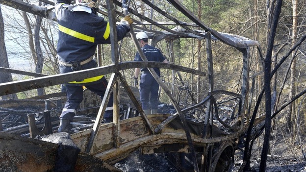 Emergency service workers inside the shell of the coach this afternoon.