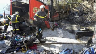 French fire brigade members work around the debris from the crashed bus.