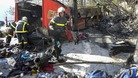 French fire brigade members work around the debris from the crashed bus.