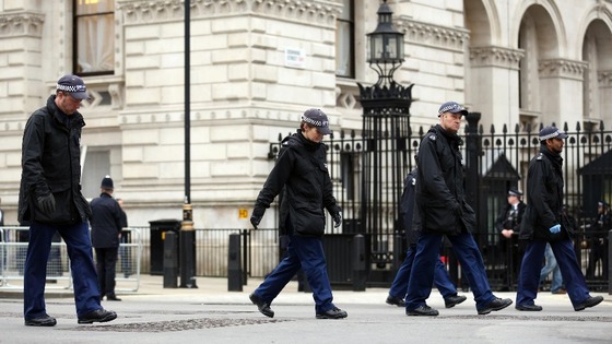 Police officers make their way along Whitehall prior to the funeral service for Baroness Thatcher at St Paul's Cathedral.