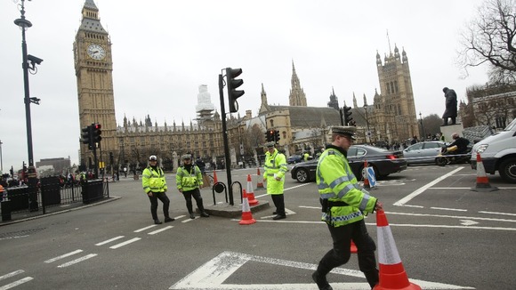 Police block off the road around Parliament Square.
