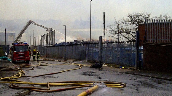 Firefighters continue to try and douse the flames at a paper mill.