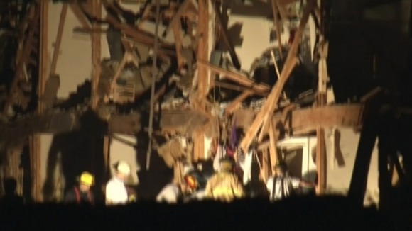 Firefighters working under a flood light