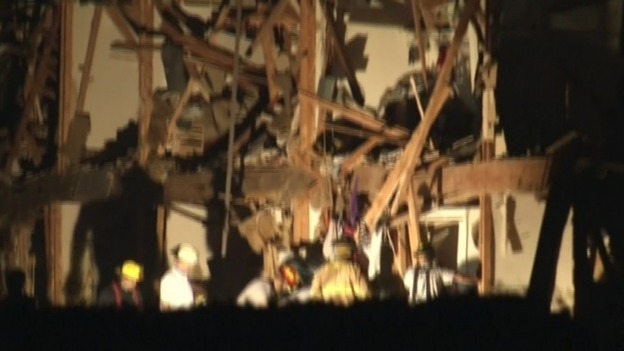 Firefighters working under a flood light
