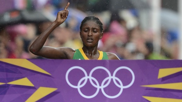 Tiki Gelana pictured crossing the finishing line to win the London 2012 women's marathon.