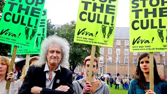 May and protestors with placards