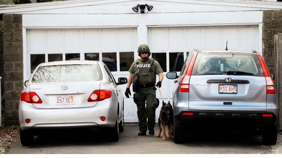 Police officers continued a house to house search for the suspect still at large.