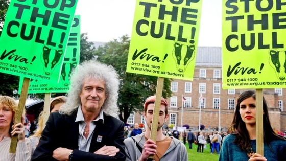 May and protestors with placards