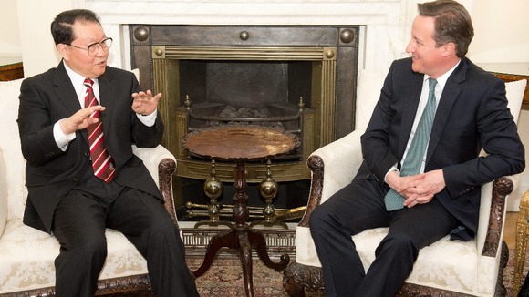 Prime Minister David Cameron talks to senior official of the Chinese Communist Party, Politburo member Li Changchun
