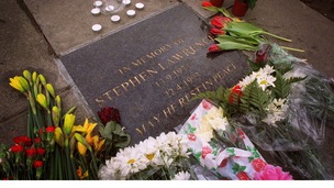 Flowers lie next to a commemorative plaque in Eltham, where teenager Stephen Lawrence was murdered in 1993.