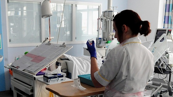 A nurse fills a syringe at a hospital in the UK