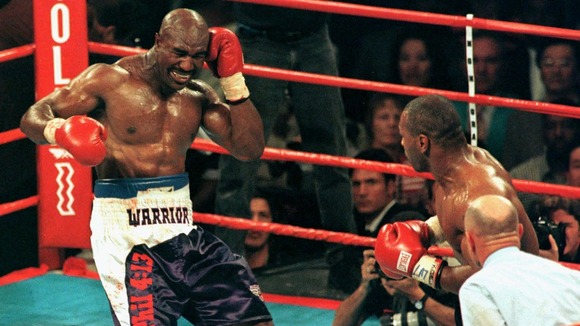 Evander Holyfield (L) recoils after Mike Tyson (R) bit his ear