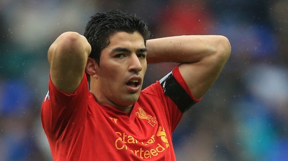 Liverpool's Luis Suarez holds his head in his hands