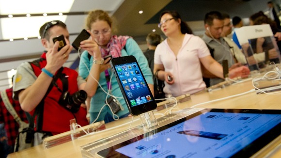 Customers looking at an iPhone5 inside the Apple Store