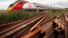 Train with rusty rails in foreground