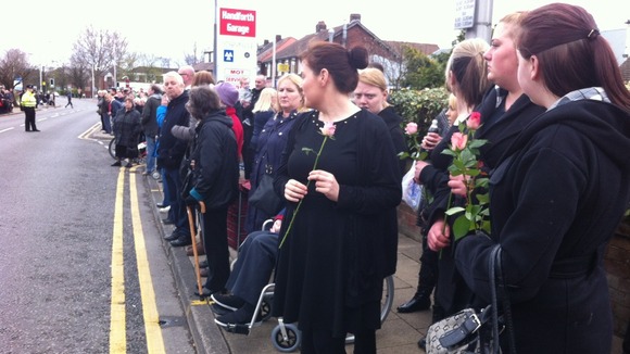 Crowds line street